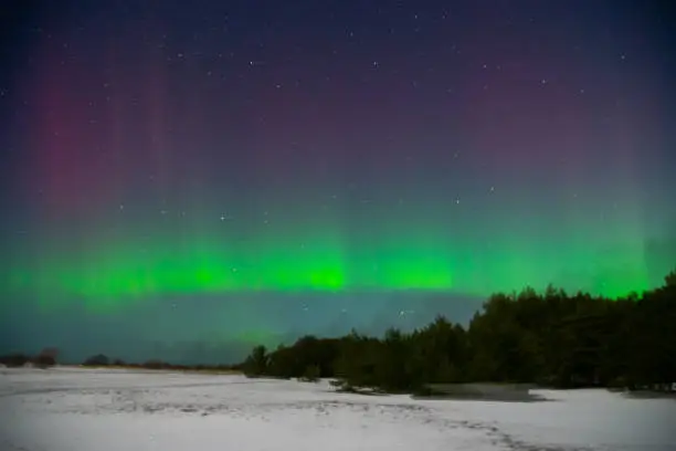 intense northern lights aurora borealis over beach in Latvia