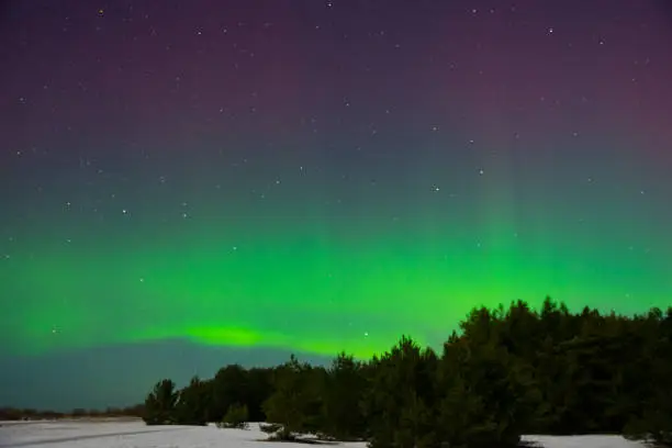 intense northern lights aurora borealis over beach in Latvia