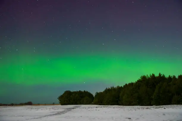 intense northern lights aurora borealis over beach in Latvia