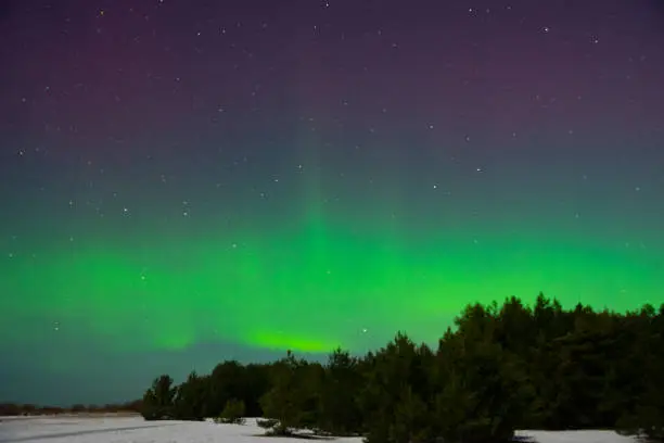 intense northern lights aurora borealis over beach in Latvia