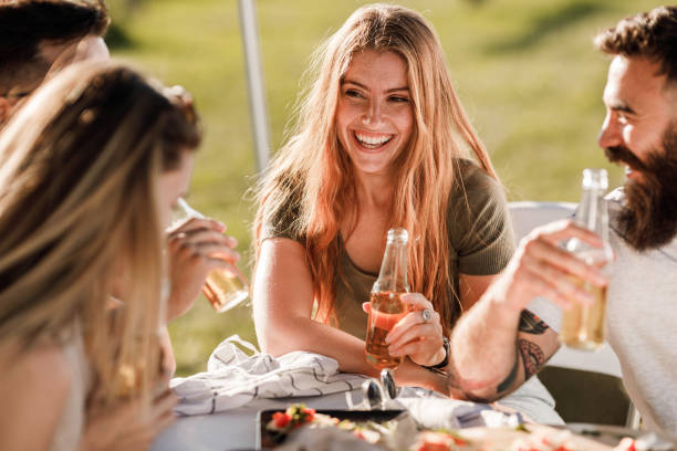 istock Happy friends enjoying in conversation during spring day in nature. 1369912925