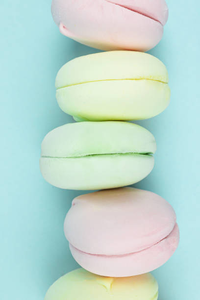 istock Close up Multi Colored Stacked Up marshmallow looks like French Macarons on Blue. 1369913161