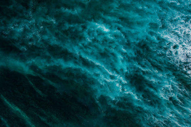 istock Big ocean waves hitting a coral reef. View from above. 1369913974