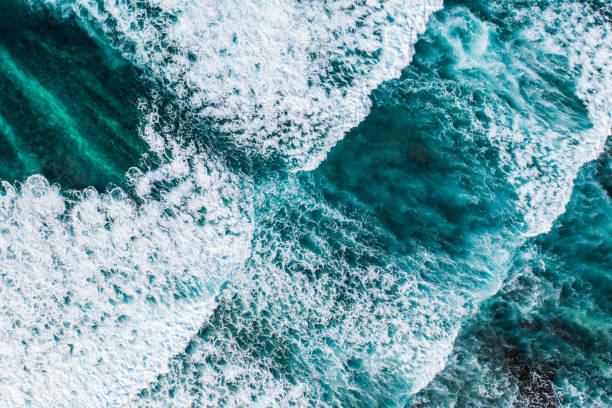istock Big ocean waves hitting a coral reef. View from above. 1369913976