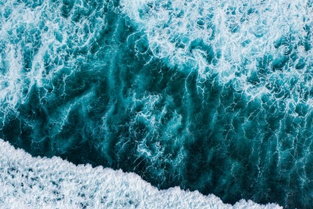 istock Big ocean waves hitting a coral reef. View from above. 1369913980