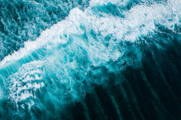 istock Big ocean waves hitting a coral reef. View from above. 1369913987