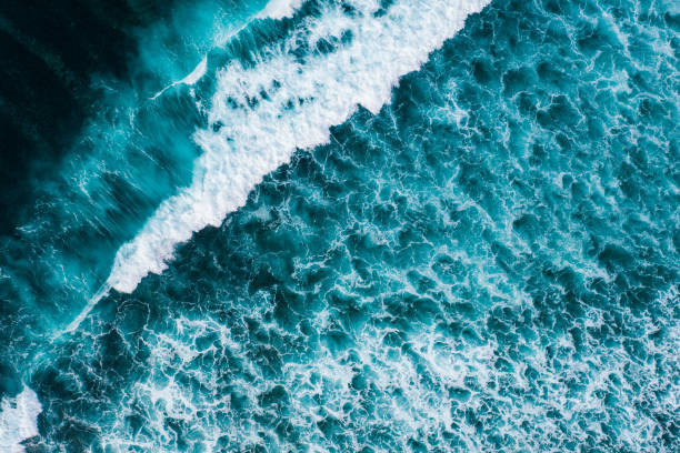 istock Big ocean waves hitting a coral reef. View from above. 1369913988