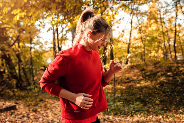 istock Young woman running in park. 1369914278