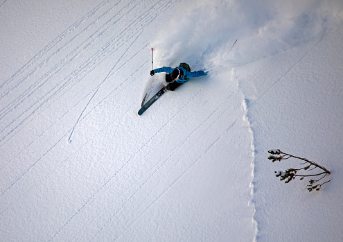 Free-skier riding in an untouched powder terrain