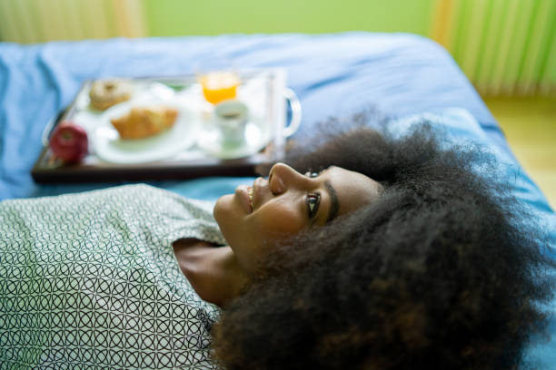 istock Close up of a smiling woman's face, lying on a bed 1369919345