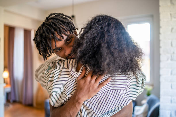 istock Romantic man and woman embracing each other at home 1369920497