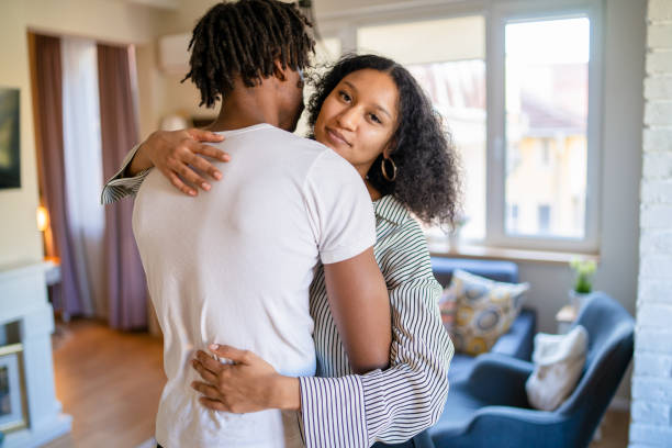 istock Woman looking at camera while hugging her boyfriend 1369920499