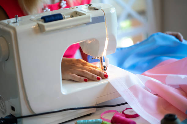 istock Close up of hands sewing transgender flag 1369920803