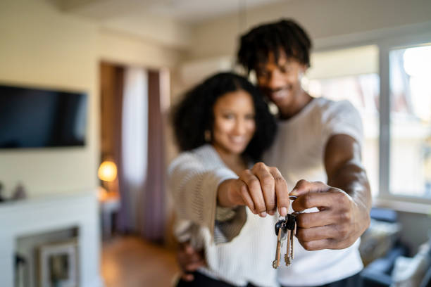 istock Close up of house keys being held by two hands 1369921303