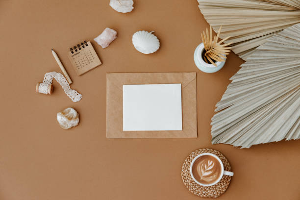 istock Aesthetic theme. Blank paper sheet card with mockup copy space, coffee cup, dry palm leaf on neutral background. Minimal business brand template. Flat lay, top view 1369921864