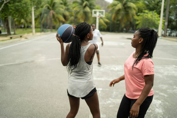 istock Three girls playing basketball 1369921886