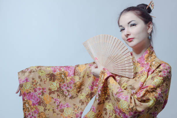 istock Japanese girl with fan 1369922111