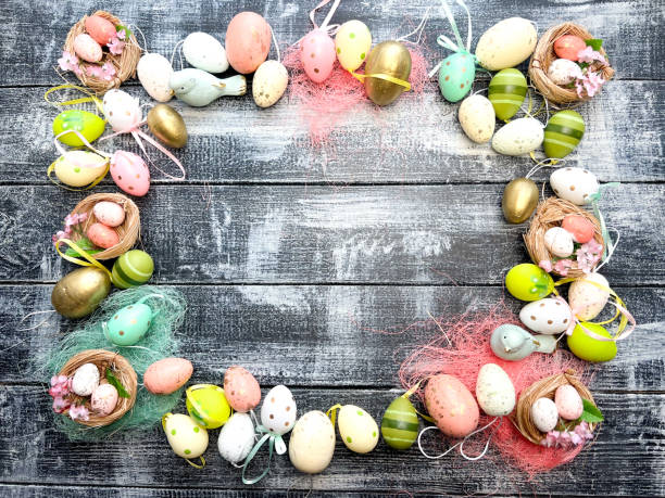 istock Frame of Multicolored Easter eggs on a cracked wtite antique background 1369923214