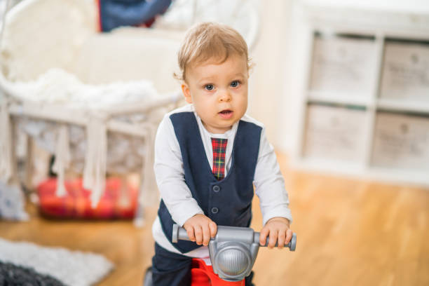 istock Baby boy rides his first bike 1369923604