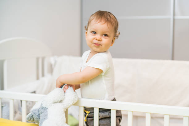 istock Baby boy in crib 1369923729