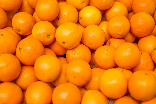 Organic oranges sale on market stall stock photo