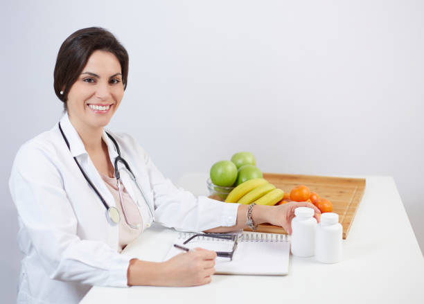 istock Beautiful smiling nutritionist 1369924803