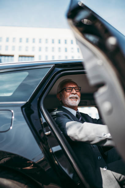 istock Senior business man in car 1369925501