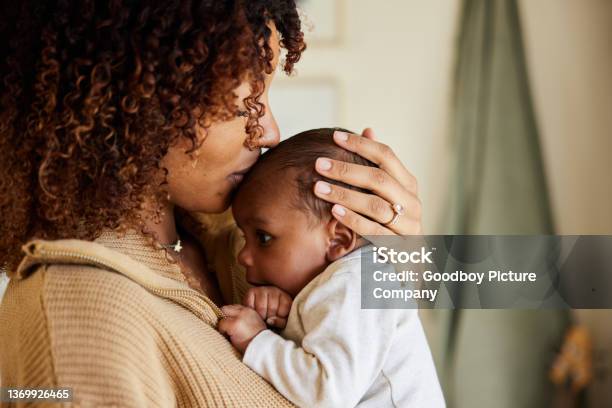 Mother Kissing With Her Baby Boy In Her Arms Stock Photo - Download Image Now - Baby - Human Age, Mother, Newborn
