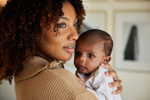 istock Mother standing with her baby boy in her arms 1369926875