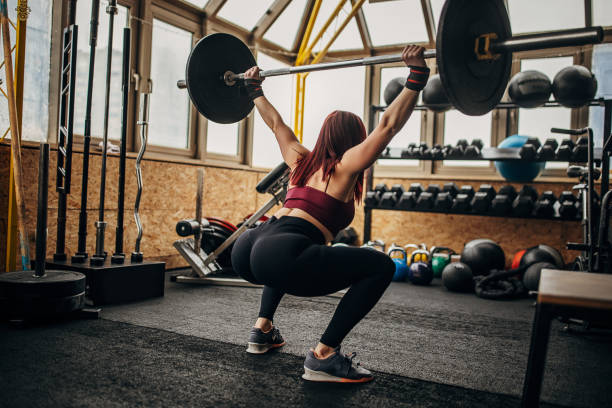 istock Fit woman exercising with weights 1369926983