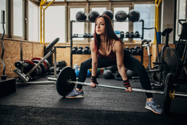 istock Fit woman exercising with weights 1369927004