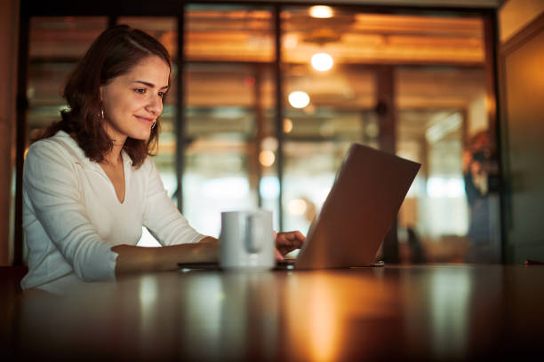 istock A businesswoman is using a laptop late at night. 1369928074