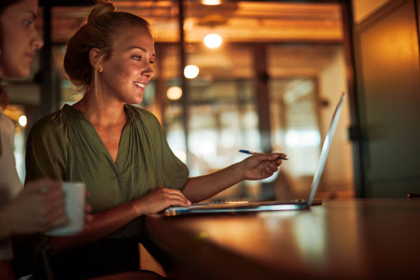 istock Two women are working in an office with a laptop. 1369928081