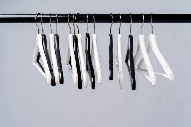 istock Metal rack with clothes hangers on grey background 1369928156