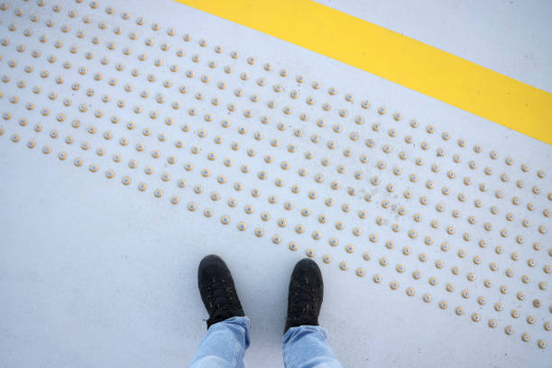 Male feet standing on blind pedestrian walking