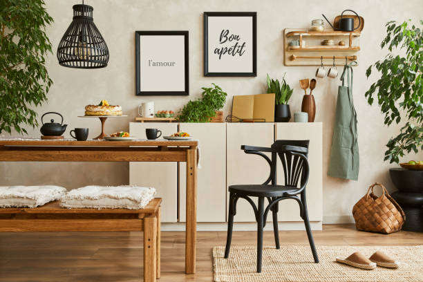 istock Stylish composition of cozy kitchen interior design with mock up poster frames, beige commode, wooden table, chair and bench and kitchen accessories. Template.