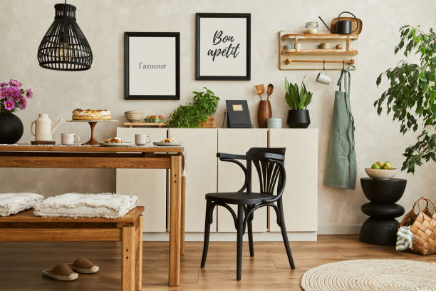 istock Stylish composition of cozy kitchen interior design with mock up poster frames, beige commode, wooden table, chair and bench and kitchen accessories. Template.