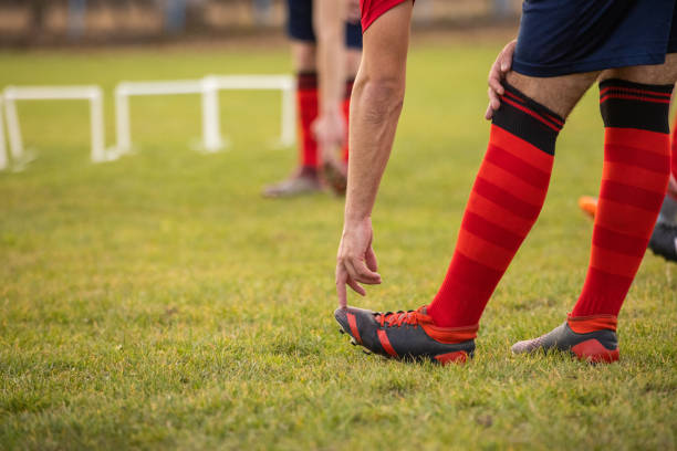 istock Unrecognizable male soccer player stretching his leg 1369934454