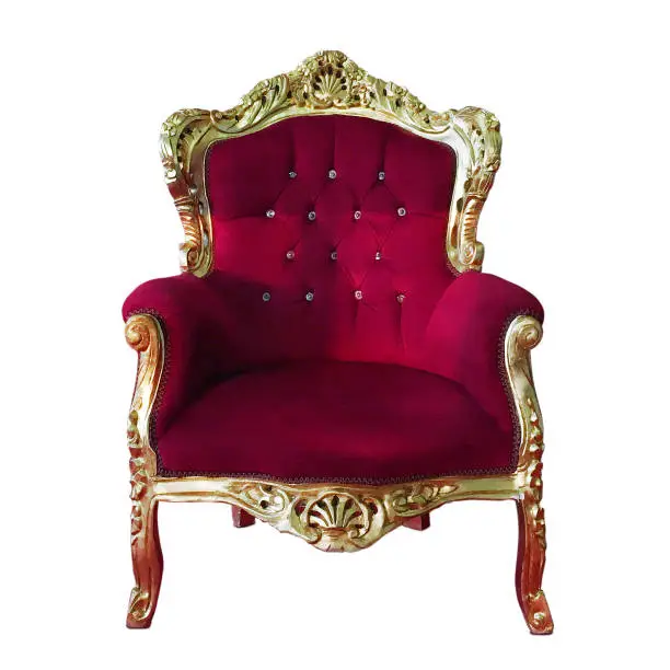 Old fashioned armchair in red velvet, isolated on white. Shot taken with mobile device.