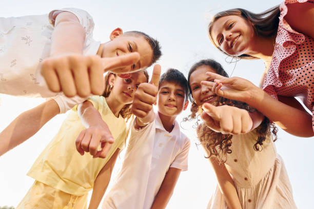 istock View from below of group of kids that looking down and having fun 1369935066