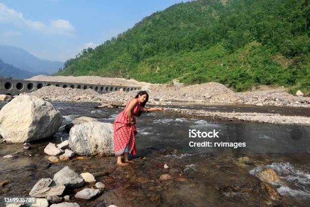 Young Female Of Indian Ethnicity Standing In Ganges River Rishikesh India Stock Photo - Download Image Now