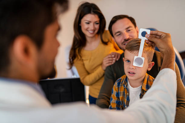 istock Mother with her son in an office with an ophthalmologist 1369936173