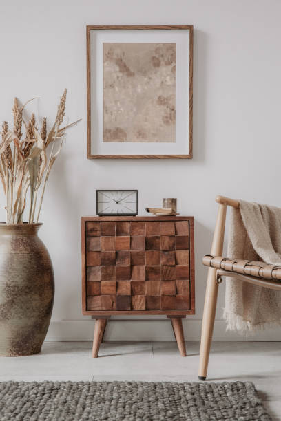 istock Creative living room interior design with wooden commode, mock up frame and vintage accessories in modern home decor. Home staging. Template. Copy space. 1369937731