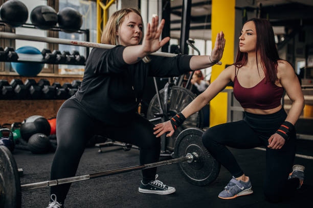 istock Personal trainer training a woman 1369937844