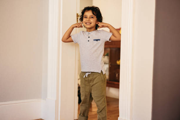istock Happy young boy covering his ears 1369938750