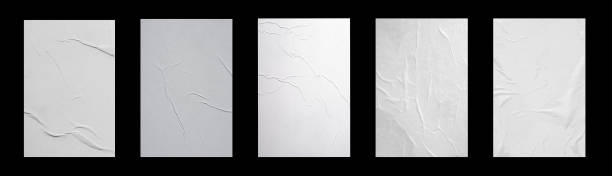istock Five white sheets with folds isolated on a black background. 1369939101
