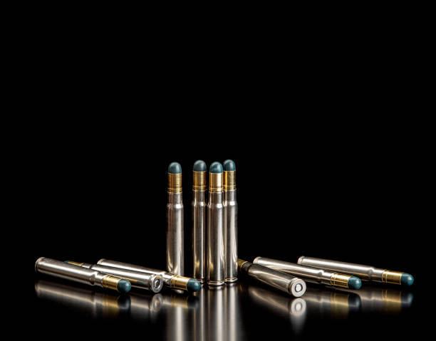 istock Bullet isolated on black background with reflexion. Rifle bullets close-up on black back. Cartridges for rifle and carbine on a black. 1369939349