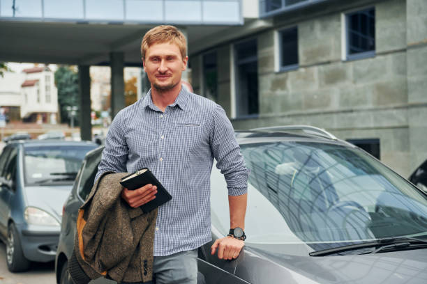 istock With notepad in hand. Man having a walk outdoors in the city at daytime 1369939961