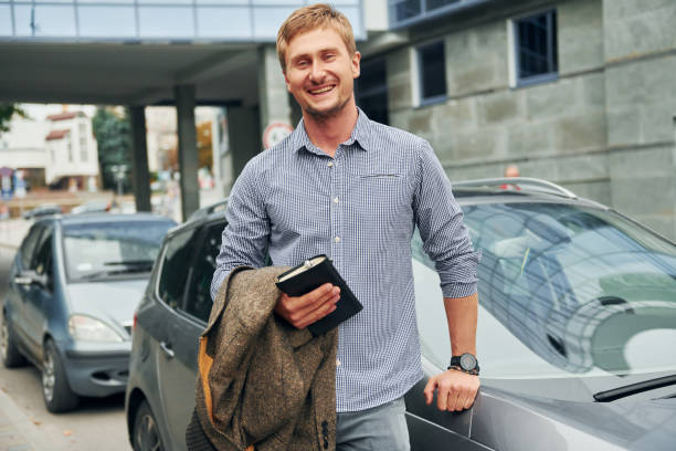 istock With notepad in hand. Man having a walk outdoors in the city at daytime 1369939974