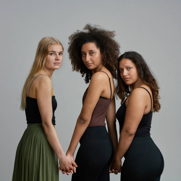istock Three young women posing close together 1369940048